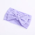 Detailed close-up of a soft light purple nylon baby headband with a large bow detail - Purple