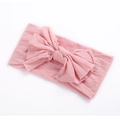 Close-up of pink soft nylon baby headband featuring a large multi-layered bow knot - Dusty Pink