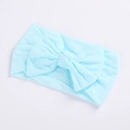 Detail of light blue nylon baby headband featuring a large soft ribbed knit bow decoration - Sky Blue
