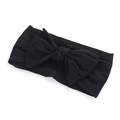 Close-up of a soft black wide headband for babies featuring a large handmade bow knot - Black