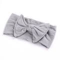 Detailed view of grey bow headband for babies made of soft and elastic cotton fabric - Gray