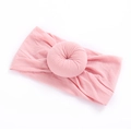 Detail of soft pink nylon baby headband featuring a ribbed texture donut knot decoration - 6 Dusty Pink