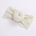 Detail of soft cream nylon elastic baby headband with ribbed texture and donut knot - Off-White