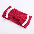 Close-up of red elastic baby headband with large bow and white pom-pom trim details - Dark Red With White Trim