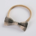 Detail of baby headband with a grey checkered cotton linen bow on elastic nylon band - Gray Plaid Bow (FHML-0107) / Grey Grid
