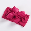 Detailed macro view of magenta grosgrain ribbon bow on soft nylon baby headband - Dark Red