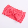 Soft coral pink nylon baby headband with a large bow and decorative pom-pom edges - Watermelon red