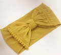 Gele elastische nylon hoofdband met zachte pompon kant en grote centrale knoop - 15 Gembergeel