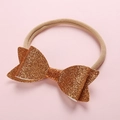 Detail of baby sequin bow headband with soft nylon elastic band on pink background - Gold Yellow
