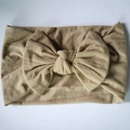Elastic beige nylon infant headband with a large handmade bow for stylish baby girls - Nude
