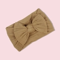 Mustard yellow knitted infant headband featuring a large bow and classic cable pattern - Dark Coffee