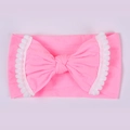 Bright pink elastic baby headband featuring a large bow with white pom-pom fringe detail - 31 Peach Pink