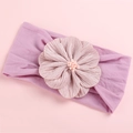 Detail of baby headband with a large silk flower and pearl stamens on pink nylon - Taro Purple