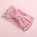 Close-up of pink cable-knit baby headband featuring a soft knit oversized bow texture - Dusty Pink