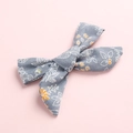 Grey floral fabric bow hair clip with white leaves and orange flowers on pink background - Grey Floral