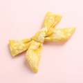 Yellow floral bow hair clip with white flower patterns for girls on a pink background - Yellow Floral
