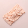 Dettaglio della fascia per neonati in maglia a trecce color pesca con grande fiocco - Rosa Scuro