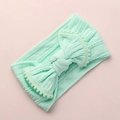 Détail du bandeau bébé vert menthe en maille côtelée avec nœud orné de pompons - Vert Clair