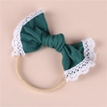 Detail of baby headband with dark green bow and delicate white lace trim on elastic band - Dark Green