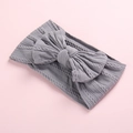 Close-up of gray cable knit baby headband showing soft fabric texture and large bow - Gray