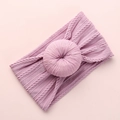 Close-up of soft pink cable knit baby headband featuring a circular donut knot detail - Taro Purple