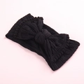 Détail du bandeau bébé en maille noire avec un grand nœud et des bords à pompons décoratifs - Noir