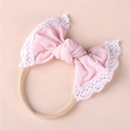 Close-up of baby headband with soft pink bow and delicate white lace edges for girls - Light Pink