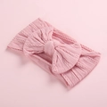 Detail of soft jacquard nylon baby headband featuring textured cable knit and large bow - Dusty Pink