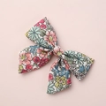 Detailed close-up of floral print fabric bow hair clip for children and babies - Multicolor Floral