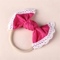 Close-up of handmade baby headband featuring a magenta bow with white lace trim detail - Rose Red