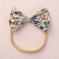 Soft nylon baby headband with a vintage floral cotton bow on a pink background - Vintage Multicolor Floral Style