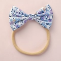 Soft floral cotton bow baby headband with stretchy nude nylon band on pink background - Blue-Purple Floral Style
