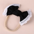 Soft nylon baby headband featuring a large black bow with delicate white lace edges - Black