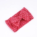 Close-up of soft nylon headband for babies featuring white polka dots and a large bow - Watermelon Red