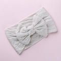 Dettaglio della fascia per neonata bianca con fiocco in morbido jacquard a pois - grigio-bianco