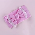 Pink elastic nylon baby headband with a large lace-edged bow shown on a soft pink background - Water Pink