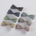 Detail shot of fabric bow hair clips with star patterns in seven vibrant assorted colors - Mixed Random