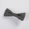 Close-up of fabric bow hair clip featuring black and white star pattern on woven texture - Black Five-pointed Star