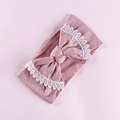 Detail of baby pink nylon headband featuring a large bow with white lace embroidery edges - Deep Pink