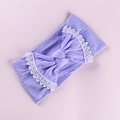 Detail of soft purple knitted baby headband featuring a white lace-edged bow decoration - Purple