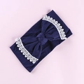 Detailed view of navy blue baby headband featuring white lace embroidery and big bow - Navy Blue