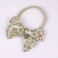 Baby bow headband featuring vintage floral cotton fabric on a soft beige nylon band - Yellow Floral