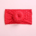 Detail of red baby headband featuring a soft knit texture and 3D donut bow knot - Red