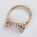 Detail of baby headband with a khaki gingham bow on a soft elastic nylon band - Khaki Gingham (5)
