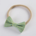 Close-up of baby nylon headband with yellow and blue plaid pattern bow detail - Yellow and Blue Gingham (8)