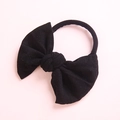 Close-up of soft black nylon baby headband with a large bow detail for girls - Black