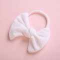 Detail shot of soft white fabric bow on elastic nylon headband for infant girls - White