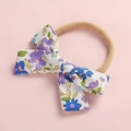 Dettaglio fascia per neonata con fiocco floreale in cotone ed elastico in nylon morbido - Fiore Viola