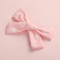 Detail of pink cotton bow hair clip with white star print on a soft pink background - Hair Bow / Pink Star