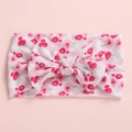 Detail shot of baby headband featuring floral rose print and large 3D bow decoration - Pink Flower